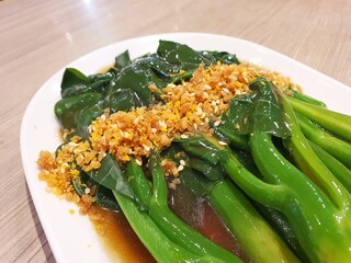 Stir fried vegetables served on a white plate. A plate of freshly served stir fried vegetable on a...