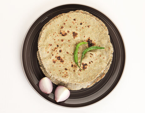 Indian traditional multigrain roti or millet flat bread.Made with chana ,caun, green moong , udad ,ragi , Jowar farmer's lunch Indian bread with chickpea powder curry