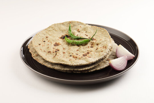 Indian traditional multigrain roti or millet flat bread.Made with chana ,caun, green moong , udad ,ragi , Jowar farmer's lunch Indian bread with chickpea powder curry