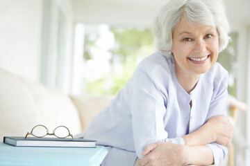 Elderly woman, portrait and relax in home on sofa for retirement, good health and weekend with...