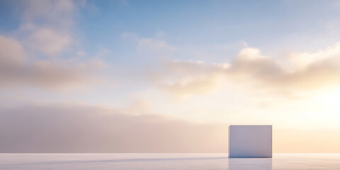 Fototapeta premium Minimalist cube against a serene sky with soft clouds at sunrise in a tranquil landscape