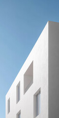 Obraz premium Modern white architectural building against a clear blue sky during the day