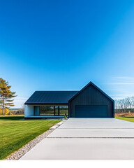 Obraz premium Modern house with minimalist design and clear blue sky in a serene rural setting
