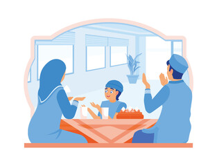 Muslim family sitting together at the dining table. Pray before breaking the fast. Ramadan Kareem concept.