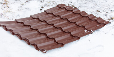 A brown roof with snow on it