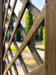 A wooden fence with a spider web pattern