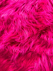 A close up of a pink fur texture