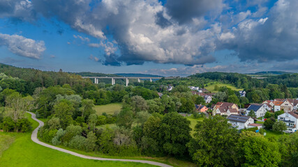 Bridge over valley with huge clouds