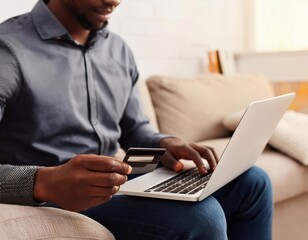 A man Holding Credit Card And Typing On Laptop For Online Shopping Payment Makes A Purchase The Internet Business Financial
