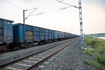 Obraz premium Railway track in India. Indian Railways Diesel-Electric Multiple Unit train