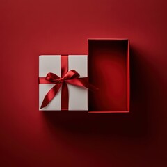 A white gift box with a red ribbon, open at the top, is placed in an empty space against a vibrant crimson background, advertisment and marketing placeholder