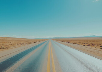 A wide-angle photograph of an empty highway in the middle of the American desert with a clear blue sky, cinematic in style, beautiful yet melancholic, minimalistic with muted tones.