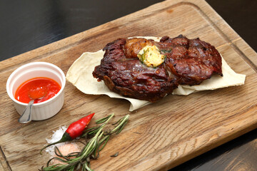 Medium rare steak placed on pita bread on a special wooden board. Beef steak on a wooden board.