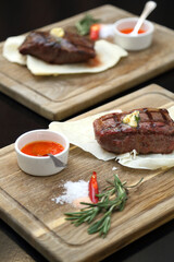 Medium rare steak placed on pita bread on a special wooden board. Beef steak on a wooden board.