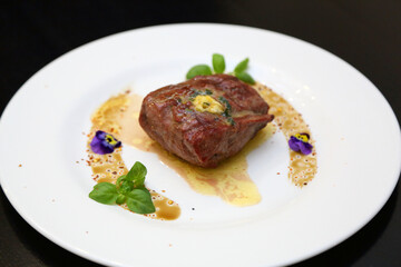 Steak on a white plate. The perfect beef steak. Medium rare steak, beautifully served on a white plate.