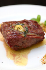 Steak on a white plate. The perfect beef steak. Medium rare steak, beautifully served on a white plate.