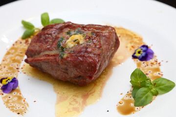 Steak on a white plate. The perfect beef steak. Medium rare steak, beautifully served on a white plate.