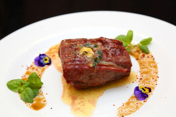 Steak on a white plate. The perfect beef steak. Medium rare steak, beautifully served on a white plate.