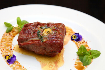 Steak on a white plate. The perfect beef steak. Medium rare steak, beautifully served on a white plate.