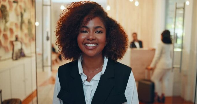 Face, woman and happy as hostess with receptionist or concierge for booking, enquiry or reservation. Female person, smile and portrait in hospitality industry or accommodation in hotel lobby as staff