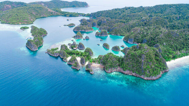 Aerial view of stunning lagoons around the island with corals reef and turquoise waters at Piaynemo Raja Ampat, Indonesia
