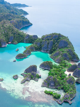 Aerial view of limestone islands and azure water and lagoon at Piaynemo Raja Ampat, Indonesia.