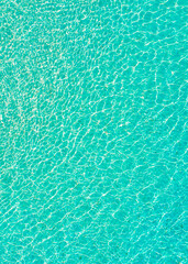 Aerial view of clear turquoise water creating ripples