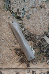 A mezuzah affixed to a stone wall at the entrance to a home in Jerusalem, Israel.