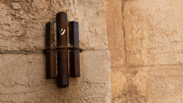 Large, rusty, metal mezuzah affixed to the Jaffa Gate entrance to the Old City of Jerusalem.
