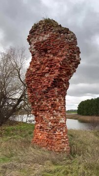 View of the Ancient Wall Remains of Piltene Castle Overlooking the Venta Riverbed on a Cloudy Autumn Day in Courland, Latvia - Static Vertical Video