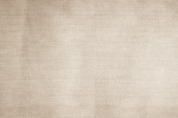 Closeup detail of beige fabric texture background. High resolution photo.