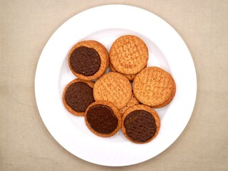 Chocolate biscuits on a white plate. Delicious and crispy chocolate biscuits, perfect for a sweet snack or dessert