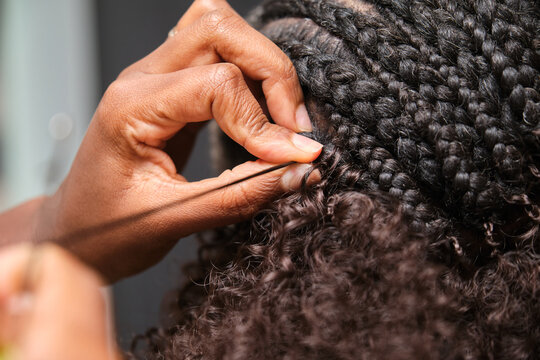 Hairdresser making crochet braids in an afro hair salon