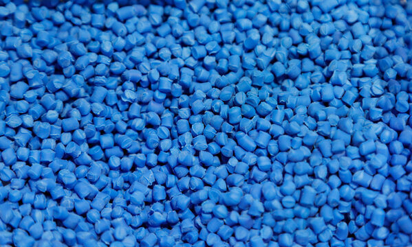 The pile of blue pellets materials for plastic injection process. The raw material from petrochemical products.