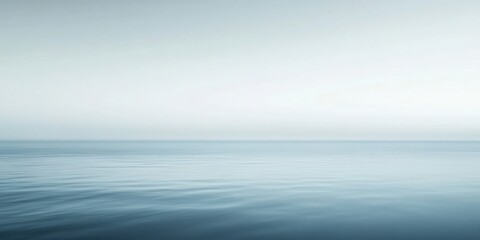 Obraz premium A serene seascape with calm waters and a soft gradient sky.