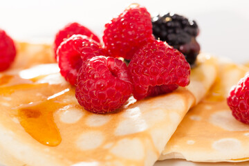 Pancakes with raspberries, blackberries and honey