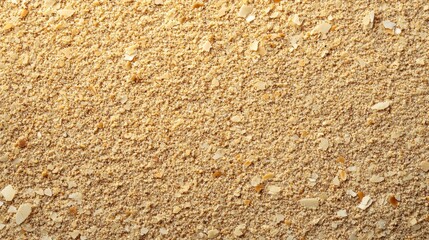 A close-up view of fine, light-colored wood shavings on a flat surface.