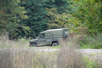 a British army Land Rover Wolf utility vehicle moving through countryside