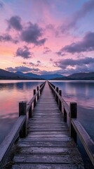 A serene sunset over a tranquil lake with a wooden pier extending