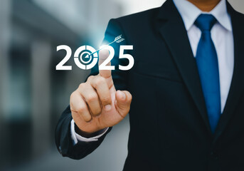Business professional in a suit touching a digital display showing the year 2025, symbolizing future goals and ambitions