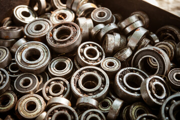 Many radial ball bearings of different sizes in a box - elements of machines and mechanisms