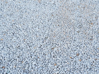 The walkway is paved with stones for easy walking. Gray stone background.Gray gravels for paving walkways surface background. Rough surface paved with grey stones
