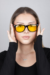 young woman wearing yellow sunglasses