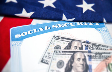 Social Security card is placed on the American flag, background. Social Security for old age people...