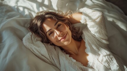 A middle-aged Latin woman with a gentle smile, lying on a bed with white linens, soft morning light warm and peaceful