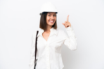 Young architect woman with helmet and holding blueprints isolated on white background pointing up a great idea