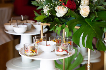 Catering service presenting delicious appetizers on cake stands during a celebration event