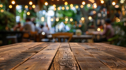 Wood table top with a blurred background of people in a coffee shop, caf�, or restaurant.