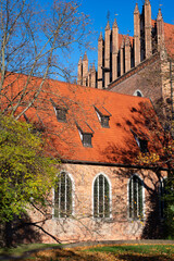 A beautiful red brick Gothic building. Ancient architecture.