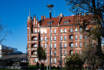 A beautiful red brick Gothic building. Ancient architecture. Living space.